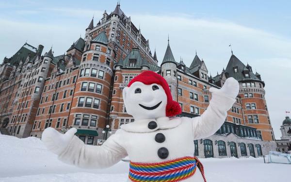 Bonhomme Carnaval poses proudly on the snow-covered Dufferin terrace, in front of the Château Frontenac.
