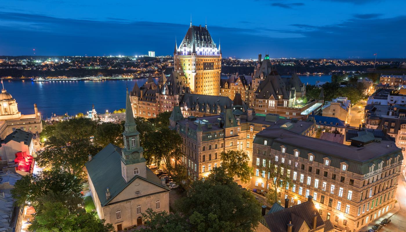 Aerial view of Old Québec illuminated in the early evening, view of Chateau Frontenac and Holy Trinity Church.