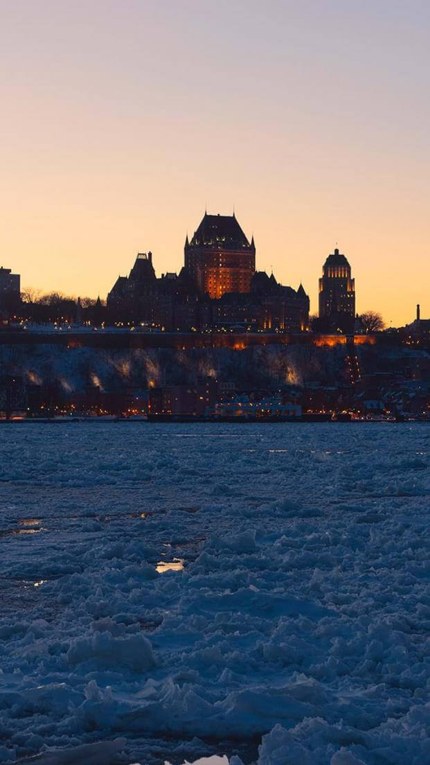 Panorama of Old Québec in winter, frozen St. Lawrence River and sunset, from the South Shore.