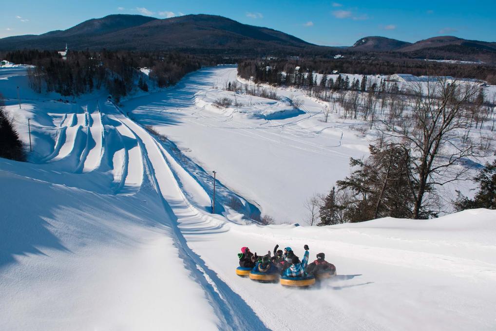The outdoor site of the Valcartier Vacation Village in winter and its inner tube slides.