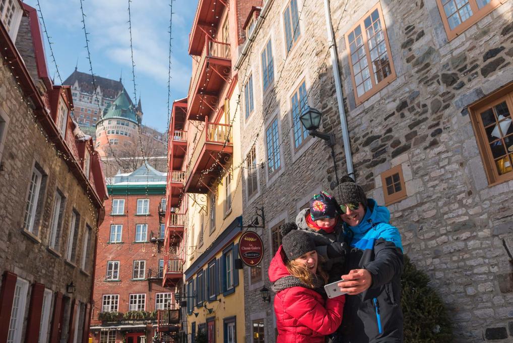 A family photograph themselves in Old Quebec City in winter