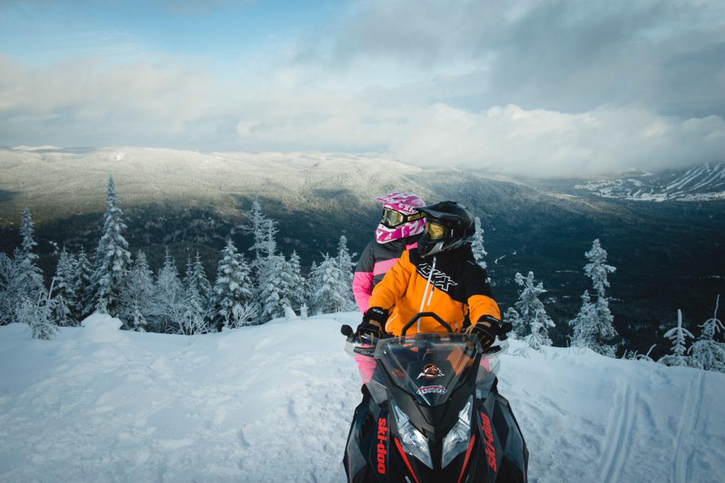 Snowmobilers at the top of a mountain in Saguenay Lac-Saint-Jean