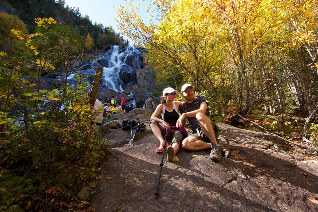 Hikers take a break in the forest, near Delaney Falls, in the Vallée Bras-du-Nord.