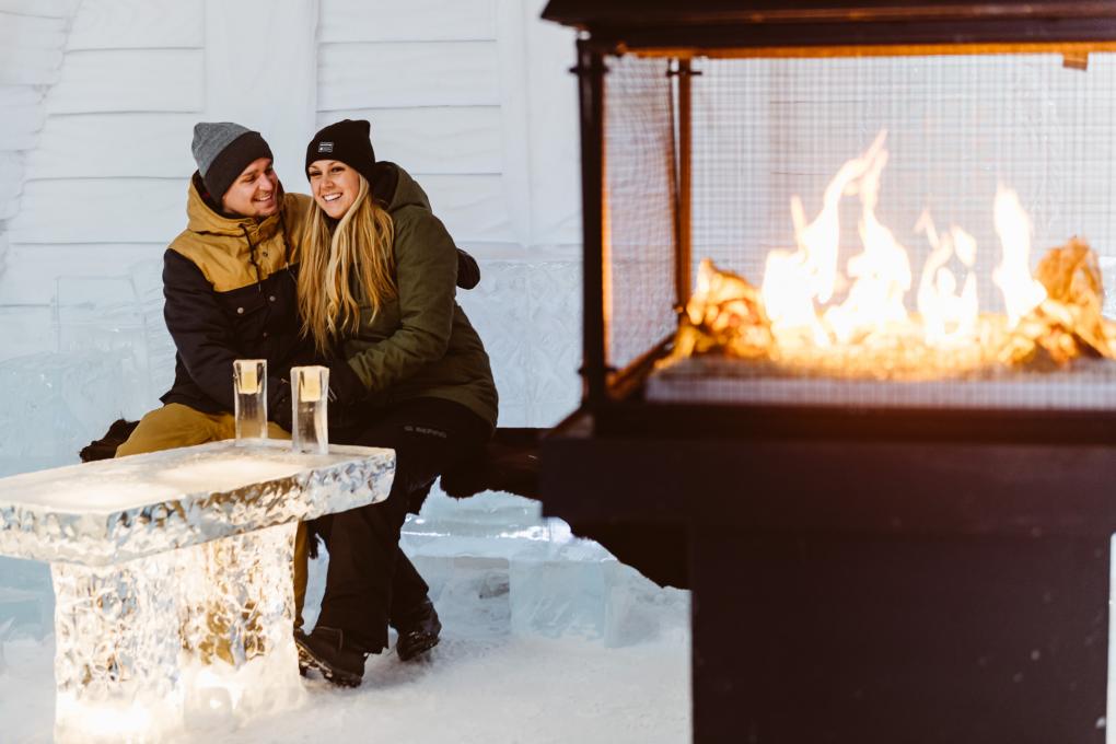A couple by the fireplace at the Hôtel de Glace, in Saint-Gabriel-de-Valcartier, near Québec.