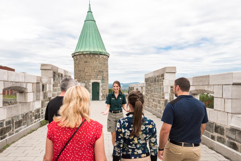 Un groupe de visiteurs participent à un tour guidé à pied du Lieu historique national des Fortifications-de-Québec.