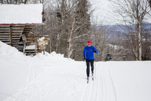 A man is cross-country skiing on the trails at Mont-Sainte-Anne.