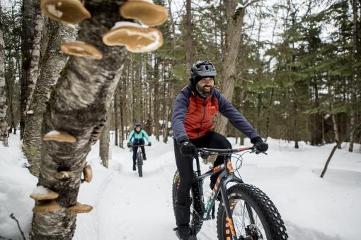 Outdoor enthusiasts ride fatbikes at Mont-Sainte-Anne.