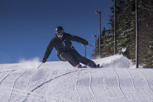 A skier goes down an alpine ski trail at Stoneham Ski Resort.
