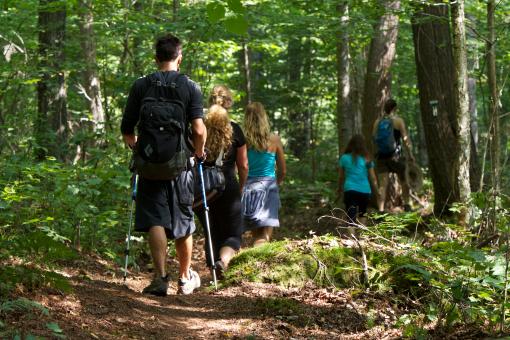 A group of hikers walk the Les Sommets trails in the Parc naturel régional de Portneuf.