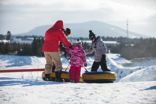 A family is getting ready to slide into the winter games center at Village Vacances Valcartier.