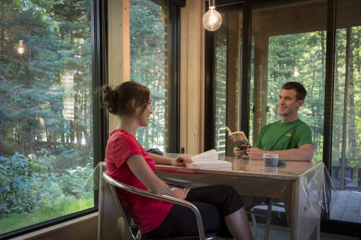 A couple inside an EXP chalet in Jacques-Cartier National Park.