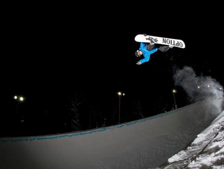 A snowboarder in one of the three snow parks at the Stoneham Ski Resort, in the evening.