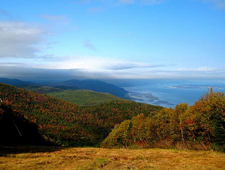 Fall colors and the St. Lawrence River seen from the top of a mountain in the Massif de Charlevoix.