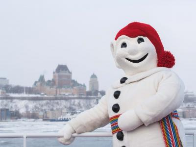 Bonhomme Carnaval is photographed on the exterior bridge of the Québec-Lévis Ferry, in winter.