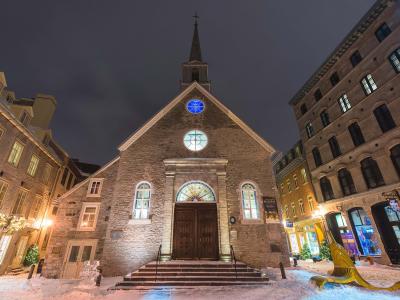 The Notre-Dame-des-Victoires church, illuminated in the evening, at Place-Royale, in the Petit-Champlain district, in winter.