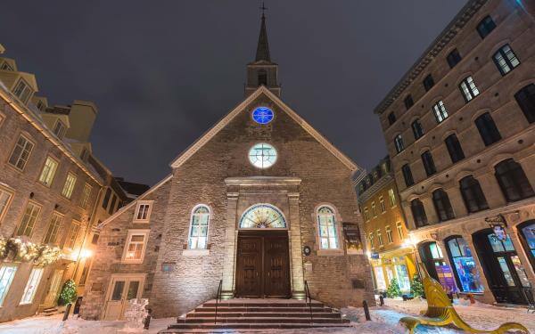 The Notre-Dame-des-Victoires church, illuminated in the evening, at Place-Royale, in the Petit-Champlain district, in winter.