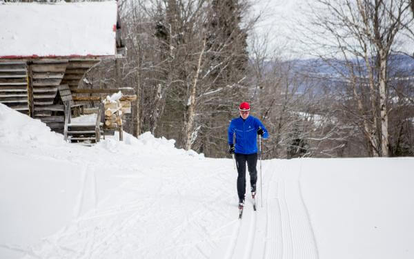 A man is cross-country skiing on the trails at Mont-Sainte-Anne.