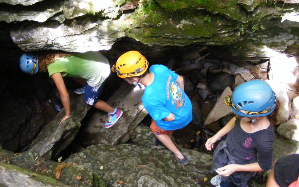 A group of children in a cave in the Parc naturel régional de Portneuf.