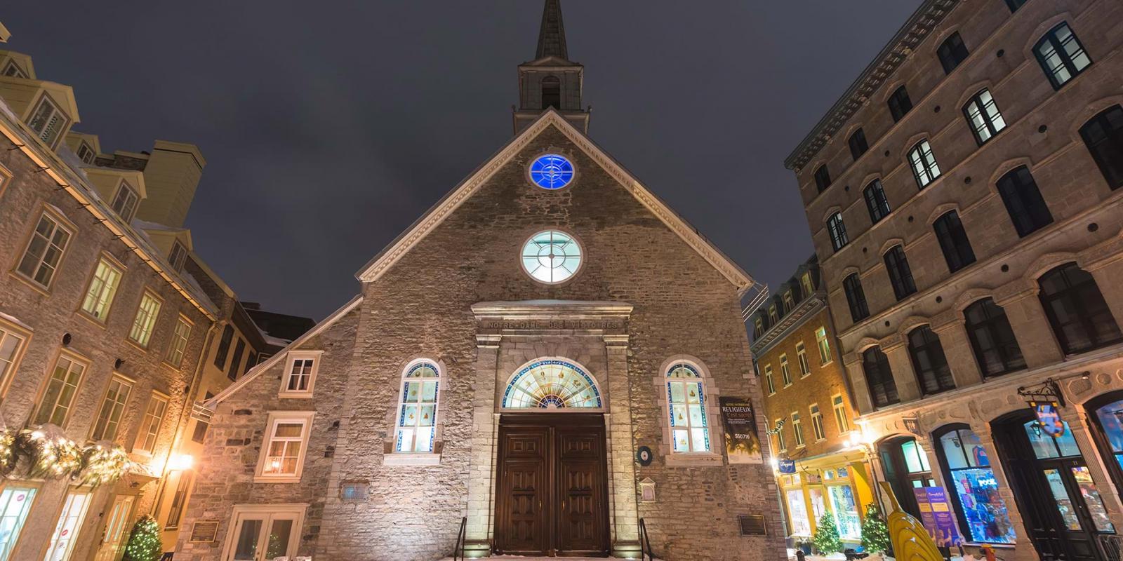 The Notre-Dame-des-Victoires church, illuminated in the evening, at Place-Royale, in the Petit-Champlain district, in winter.