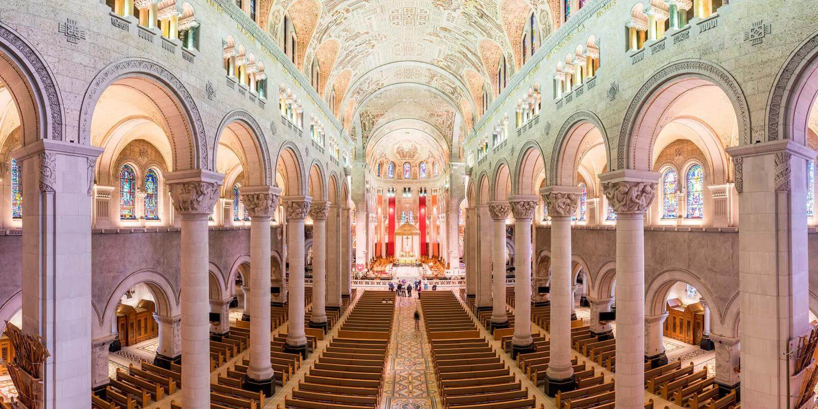 Impressive view of the interior of the Sanctuary of Sainte-Anne-de-Beaupré with its columns and detailed ceiling.
