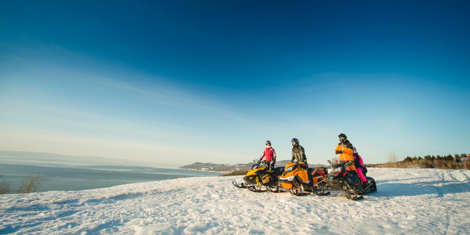 Snowmobilers overlooking the St. Lawrence River in Charlevoix
