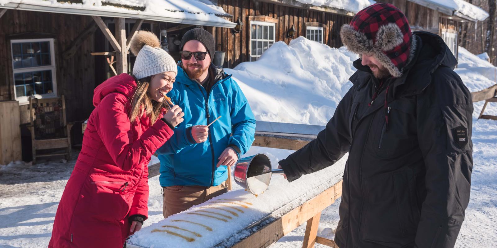 Maple taffy served to a couple at the sugar shack