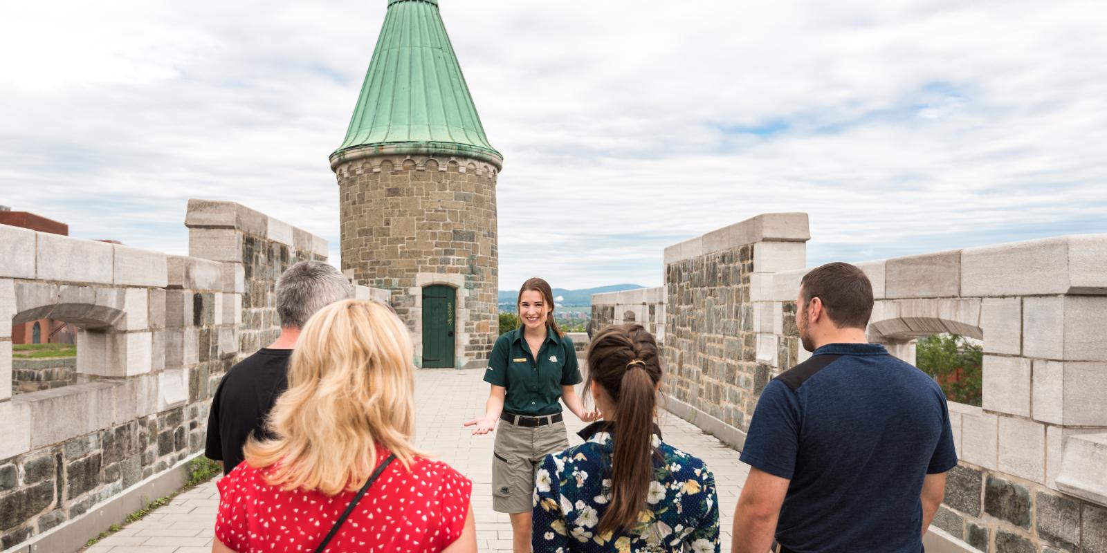 A group of visitors take part in a guided walking tour of the Fortifications of Québec National Historic Site.