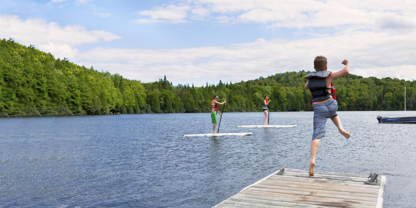 Swimming and paddle boards in the lake of the Station touristique Duchesnay.