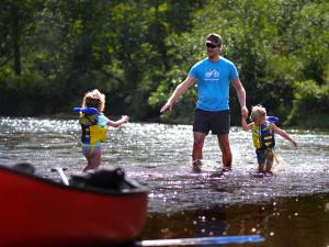 Family swimming in the river, in the Vallée Bras-du-Nord.