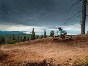 A cyclist enjoys the trails and the beautiful view on a mountain bike in the Massif de Charlevoix.