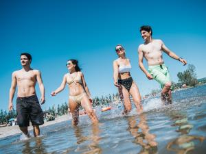 Friends enjoy swimming in the St. Lawrence River at Baie de Beauport.