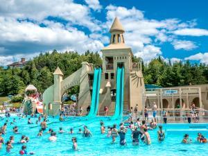 Water slides and outdoor swimming pool at Village Vacances Valcartier, in summer.