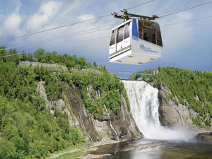 The Parc de la Chute-Montmorency cable car with the view of the waterfall in the background.