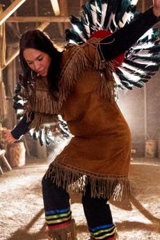 A Native American dancer performs a traditional dance inside the longhouse in Wendake.