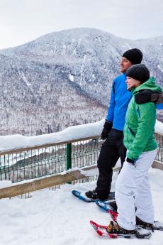 A couple snowshoes in the winter on the Les Loups trail in Jacques-Cartier National Park.