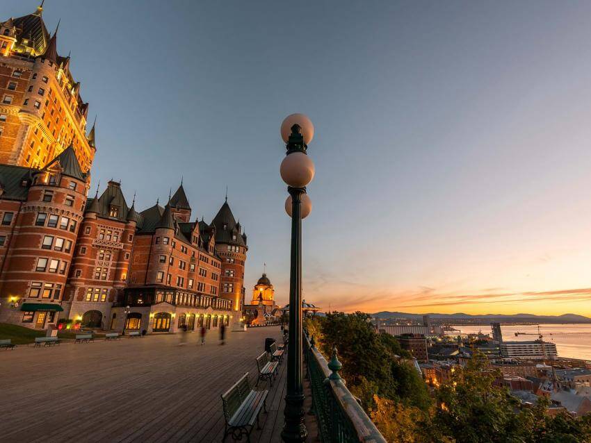 The Fairmont Château Frontenac, the Dufferin terrace and the sunrise over the St. Lawrence River.