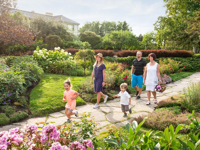 Family walking through Jardins de Métis (Redford Gardens)