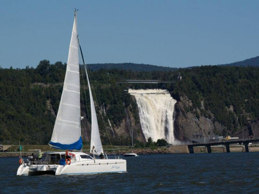 Sailboat on the river in front of Montmorency Fall