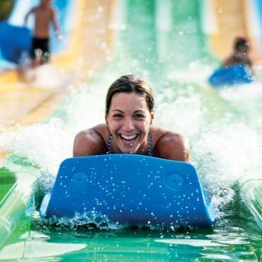 A woman slides down the Turbo 6 water slide at Village Vacances Valcartier, in summer.