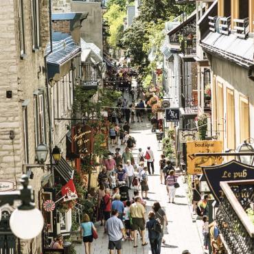 Tourists walk on rue du Petit-Champlain in summer.