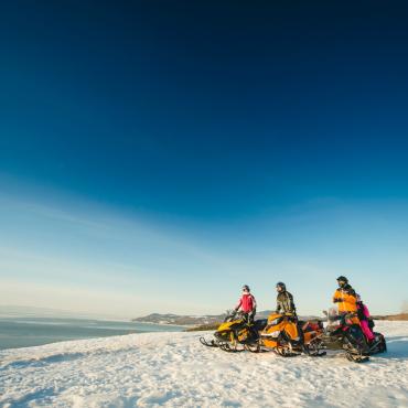 Snowmobilers overlooking the St. Lawrence River in Charlevoix