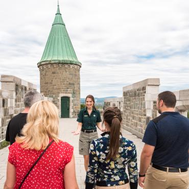 A group of visitors take part in a guided walking tour of the Fortifications of Québec National Historic Site.